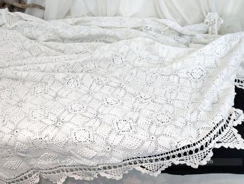 Sur 195 x 210 cm, voici un ancien couvre-lit tout au crochet fait main en fil de coton blanc composé de carrés aux décors en relief cousus entre eux. Piece unique.