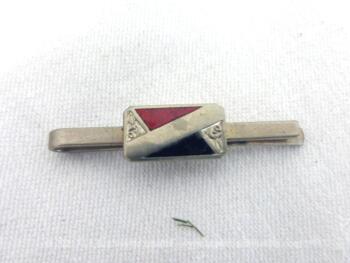 Voici une ancienne pince à cravate avec un motif carré décoré par deux triangles en émail, un noir et un rouge, et une petite rose en relief dans les coins.